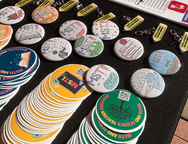 MSTI buttons, stickers, and keychains on display.