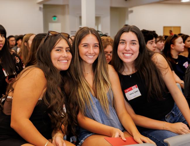 Three students in a group picture at NSO