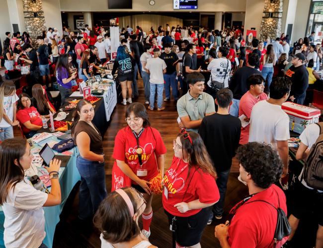 A crowd of students can be seen exploring table booths at NSO