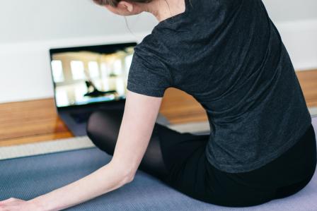 Woman doing yoga on Zoom.
