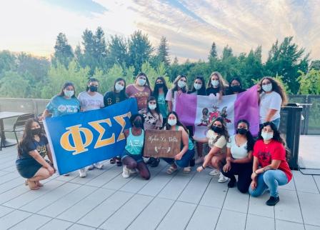 People gathered with sorority signs