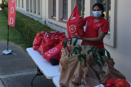 Image of Pop-Up Food Pantry (i.e. table, bags of food, and presiding staff)