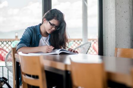 Student writing in a journal