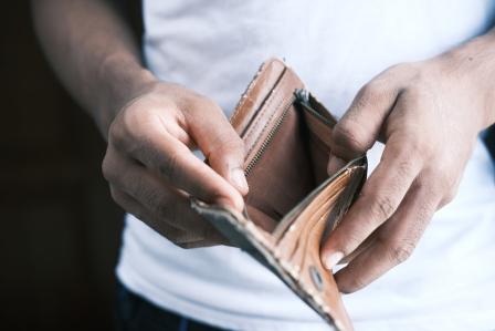 Man opening empty wallet