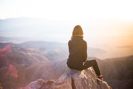 woman standing on cliff