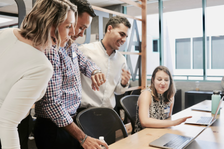 group of employees around a desk