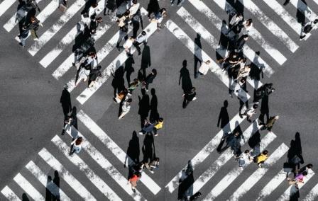 People walking across a crosswalk