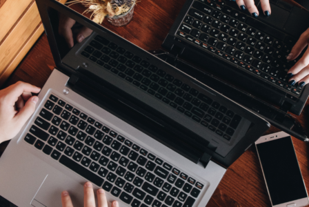 Two computers at a cafe table