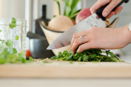 person cutting vegetables with a knife