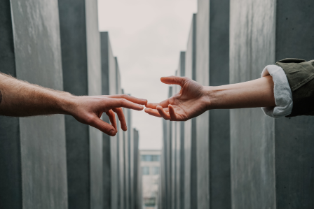 a hand reaching out to grab another hand