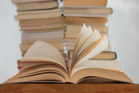 white book on a brown wooden table