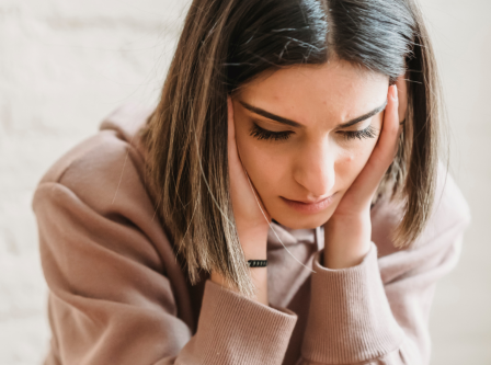Person with their head in their hands, looking stressed