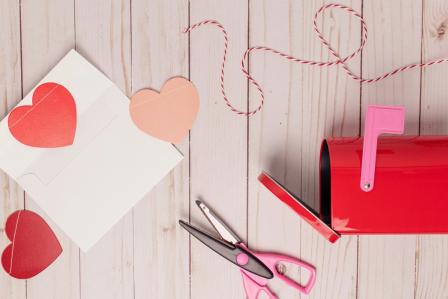 red paper hearts with an envelope and a mail box