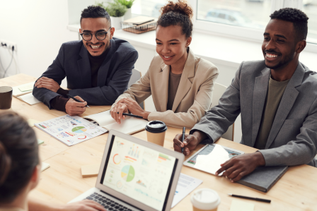 young professionals having a meeting around a laptop. 