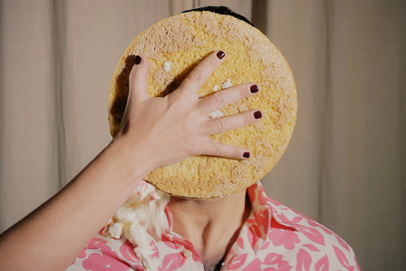 a pie being thrown in a persons face