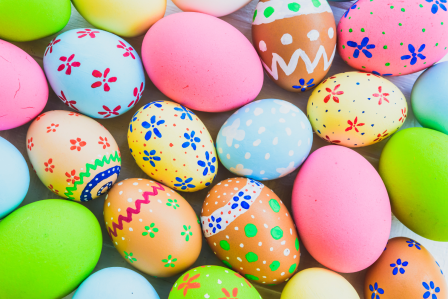 an assortment of easter eggs in different colors and patterns spread out on a table.