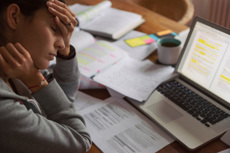a person who looks stressed over the amount of work in front of them 