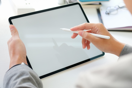 Student holder a stylus drawing on a tablet