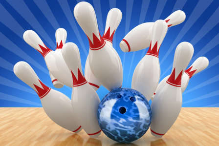 A bowling ball hitting bowling pins