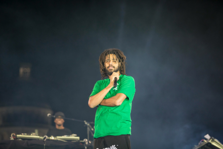 Music artist, J. Cole, on stage performing.