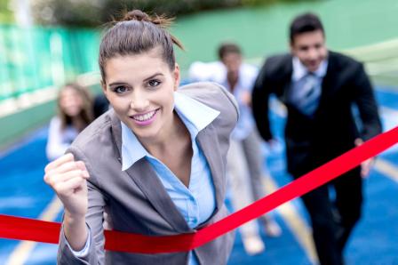 Business woman running across finish line