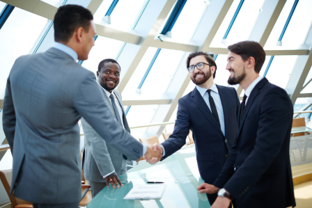 Two men shake their hands.