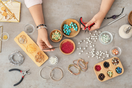 Arial view of someone putting together a beaded bracelet.
