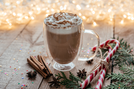 Hot cocoa with cinnamon sticks and candy canes.