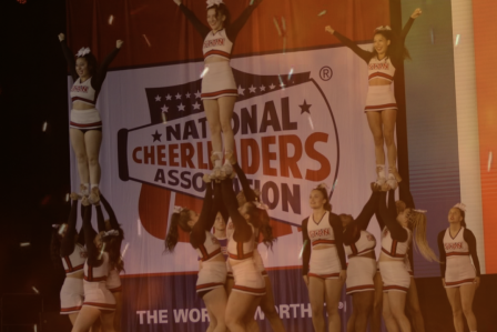 Cheer Team in a stunt formation on stage