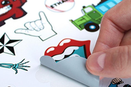 Hand peeling off stickers