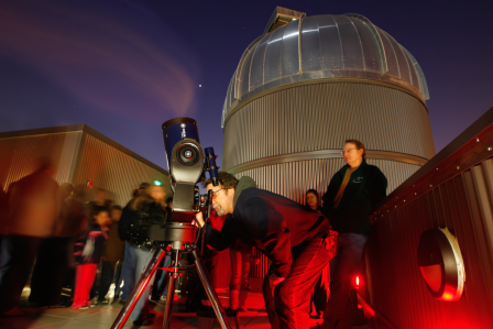 People on the Naraghi Hall rooftop, looking out of a telescope