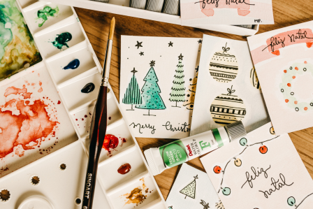 Arts and crafts supplies on top of holiday cards