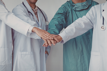 Healthcare workers putting their hands together