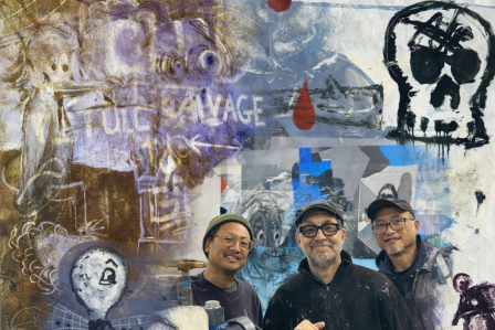 Artists standing in front of their artwork