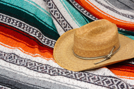 Traditional mexican blanket with hat on top