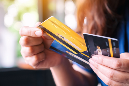 person holding credit cards