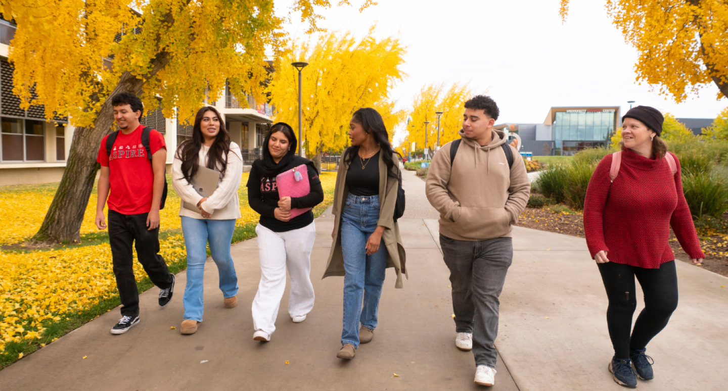 6 students walking on campus