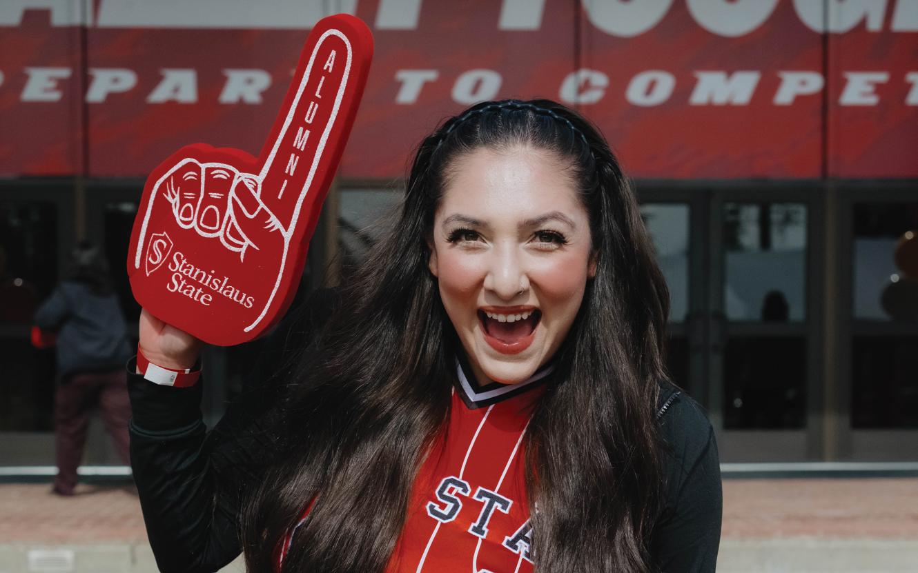 student celebrating outside athletics Fitzpatrick Arena