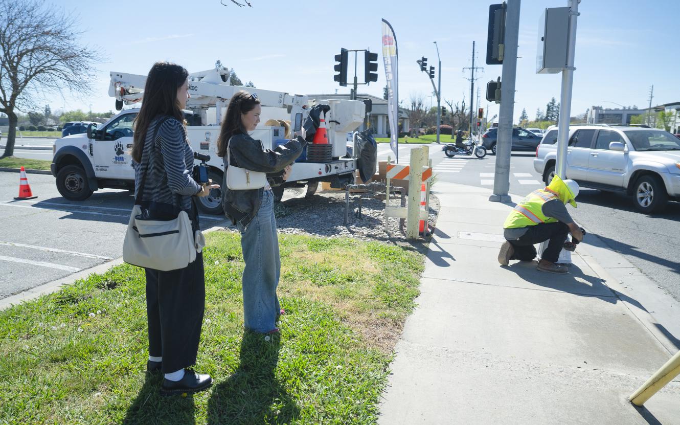 students covering newly activated red-light camera in Modesto