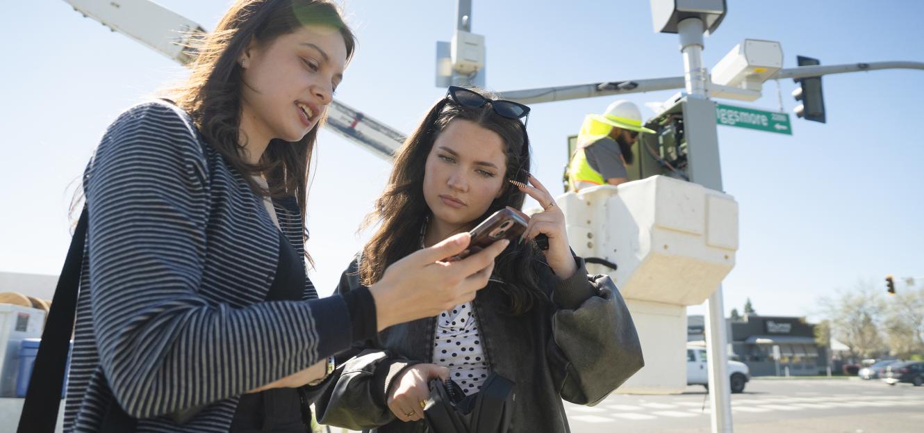 students covering newly activated red-light camera in Modesto