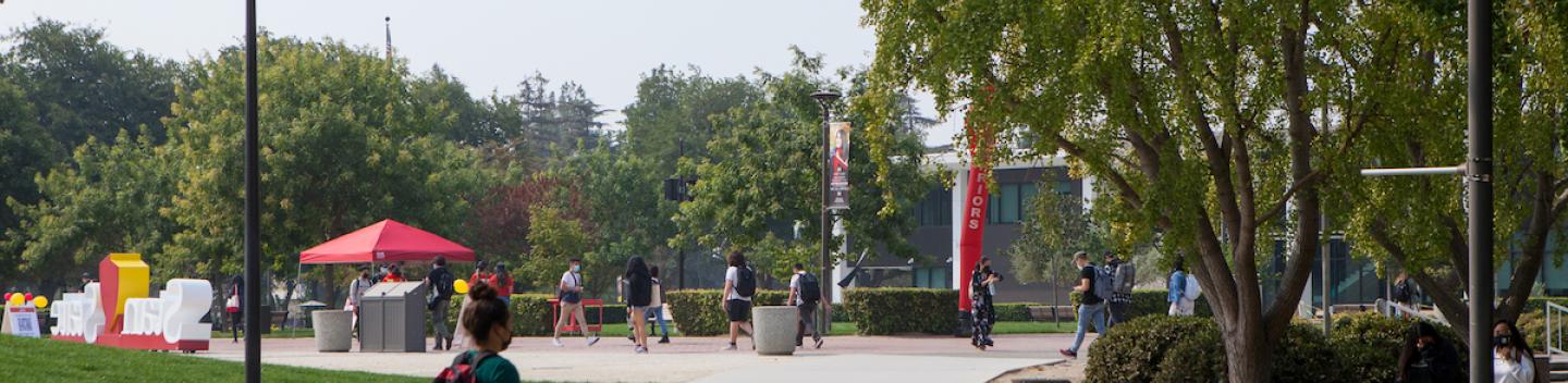 Student walking on Stan State campus.