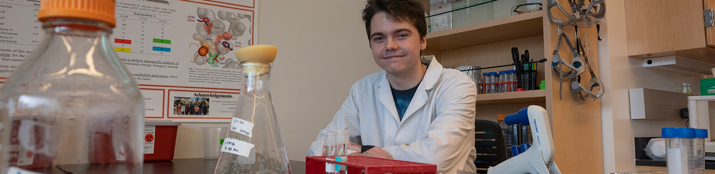 Eli Frazer standing inside a science lab. 