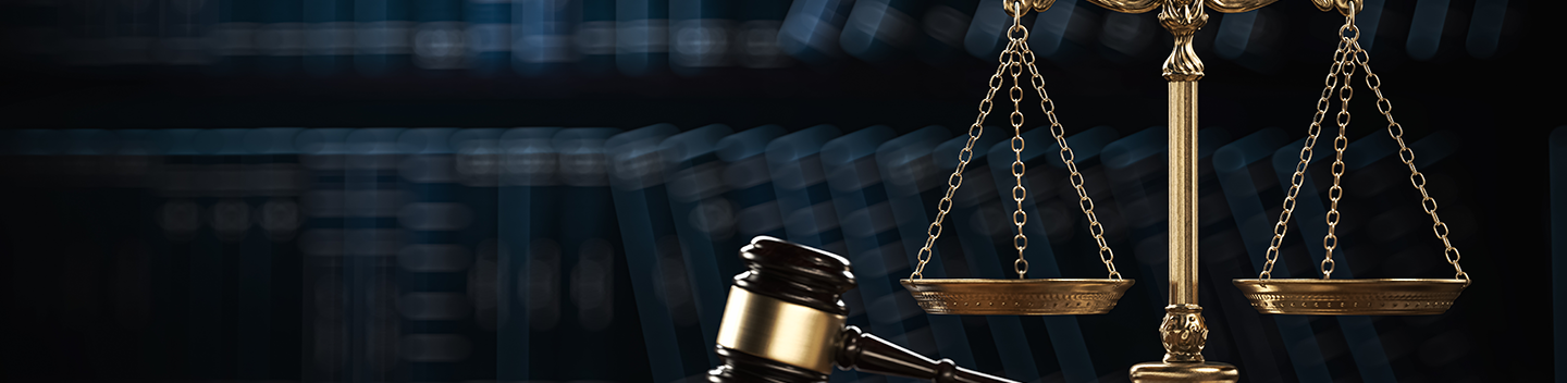 Scales of justice and a gavel on a desk