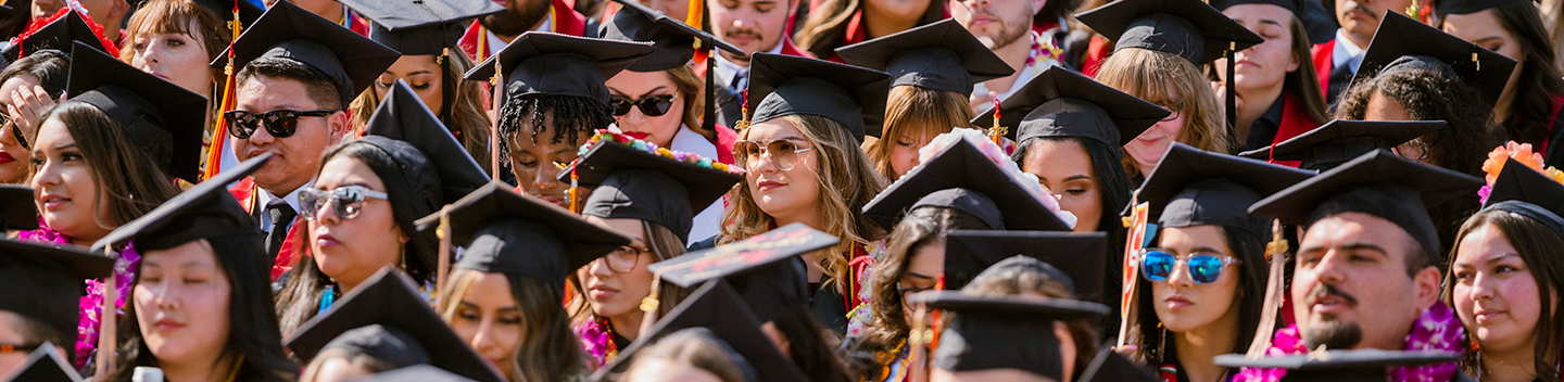 A sea of seated graduates during commencement.
