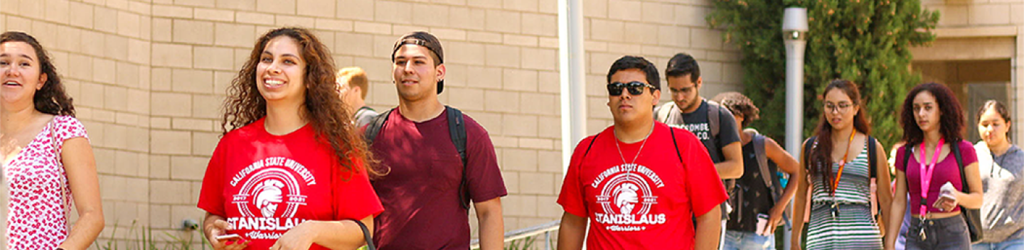 Stanislaus State students walking outdoors on campus.
