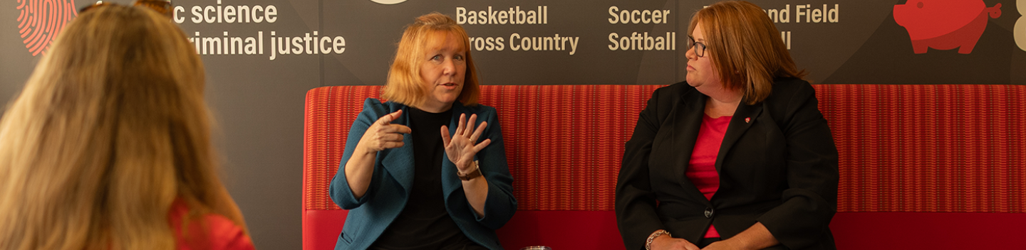 Sarah Sweitzer and Amy McKinney seated on a couch at the Stockton Campus.