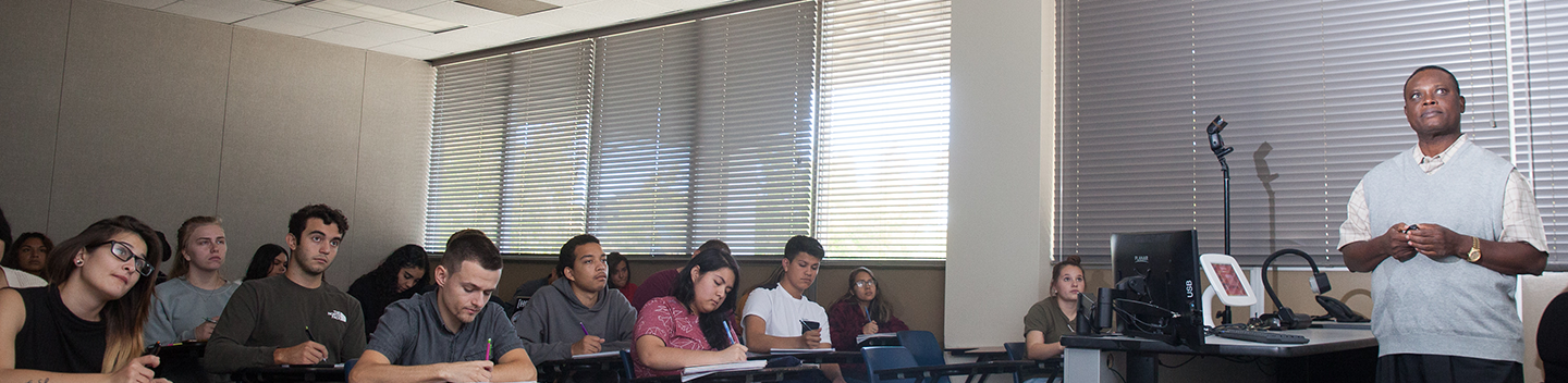 Classroom filled with students as an instructor teaches.