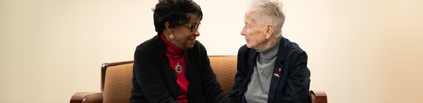 Wanda Bonnell and Donna Pierce sit together on a bench.