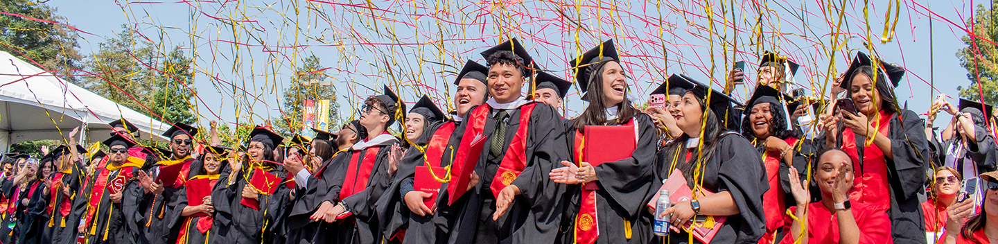 Confetti rains down on graduates during Commencement.
