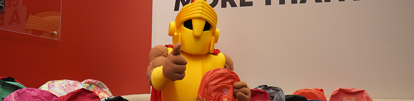 Stanislaus State's Titus poses with an assortment of backpacks.